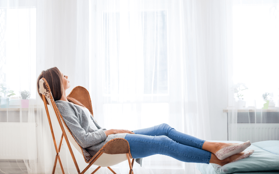 A woman relaxing in a chair.