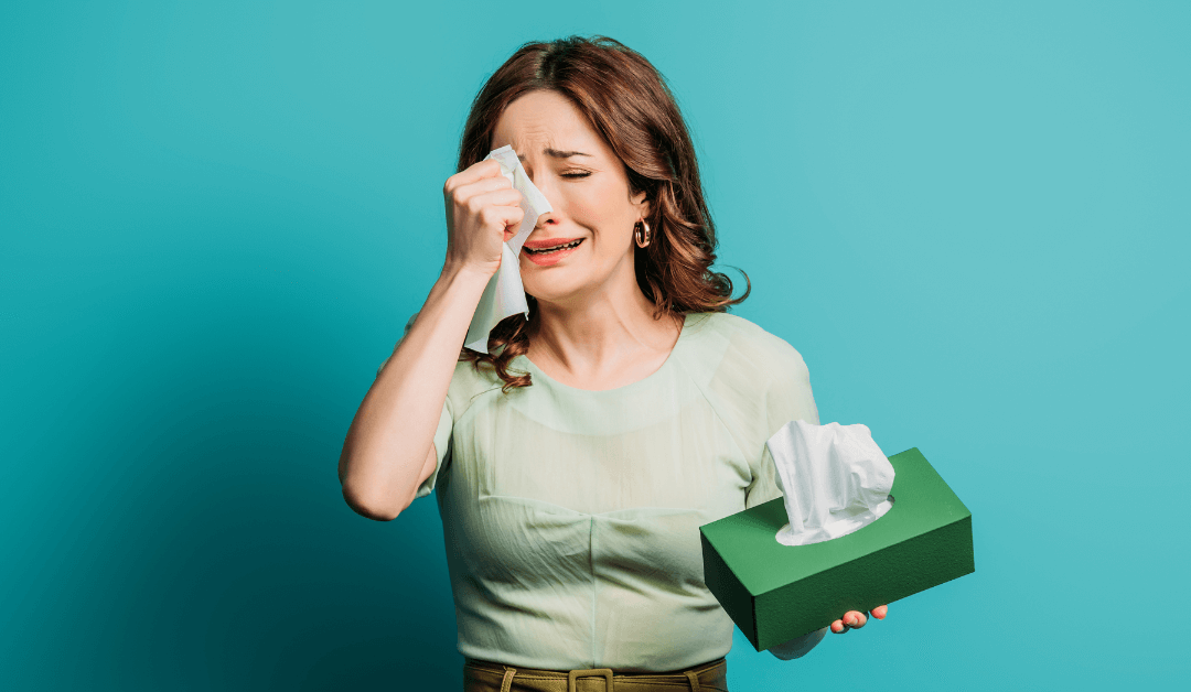 Woman being emotional: She cries into a tissue.