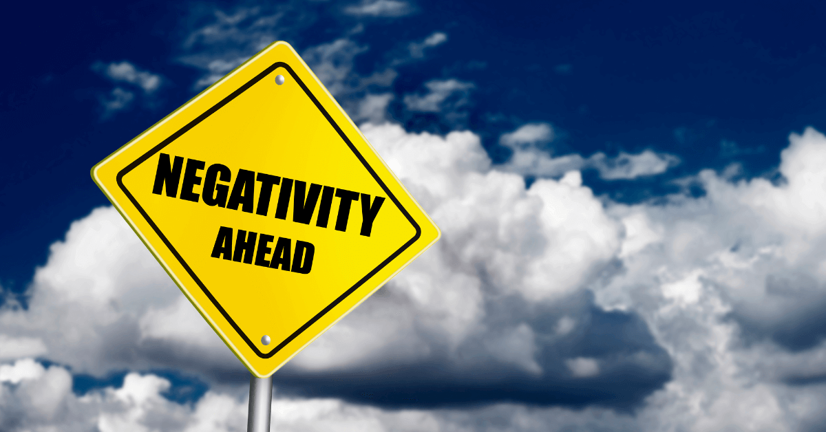 A road sign with the words negativity ahead announces the negativity bias.