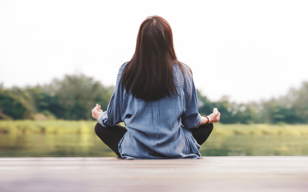 Woman sits in meditation.