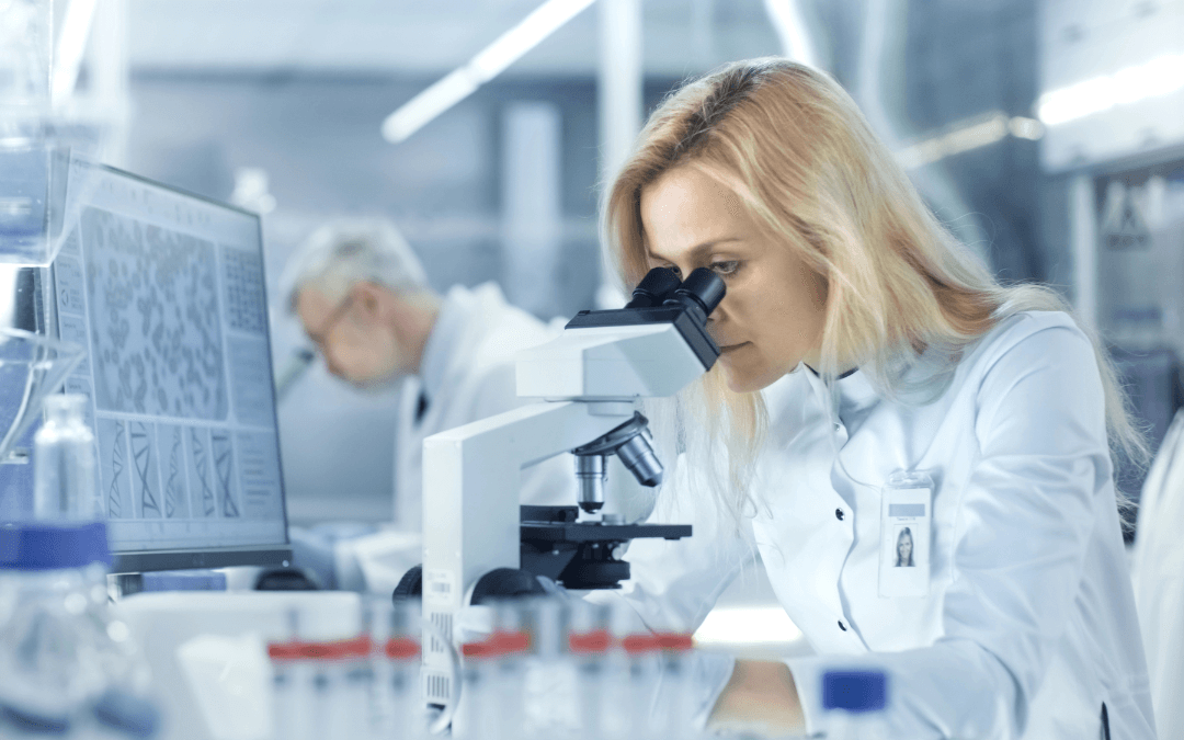 Scientist looking through a microscope.