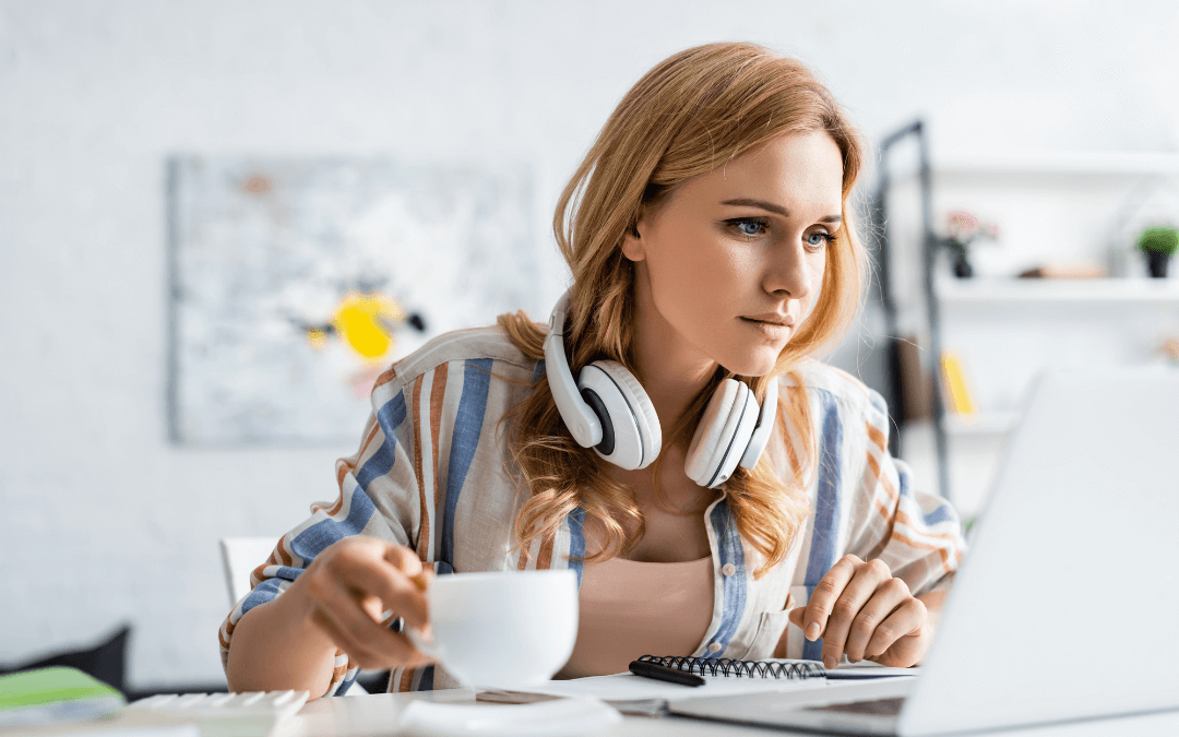 A woman learns in front of her laptop.